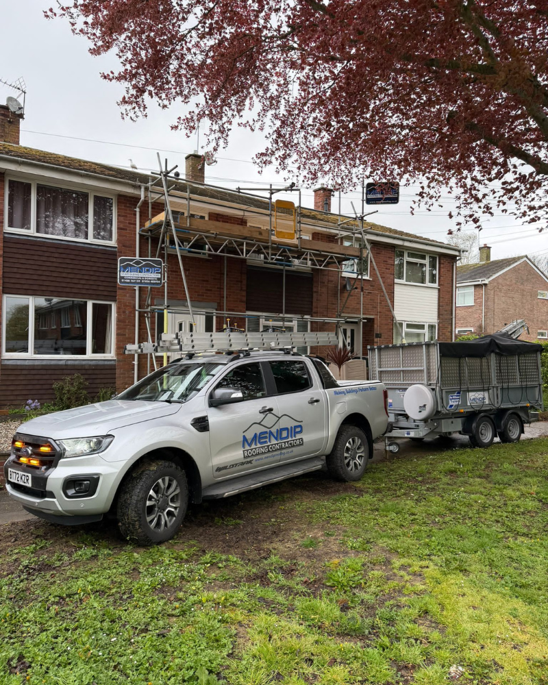 Mendip Van outside a house with scaffolding